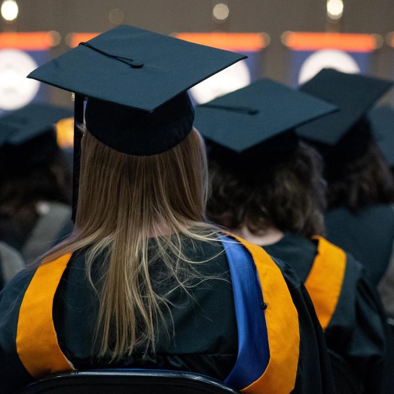 A University of Mary student sitting at commencement.